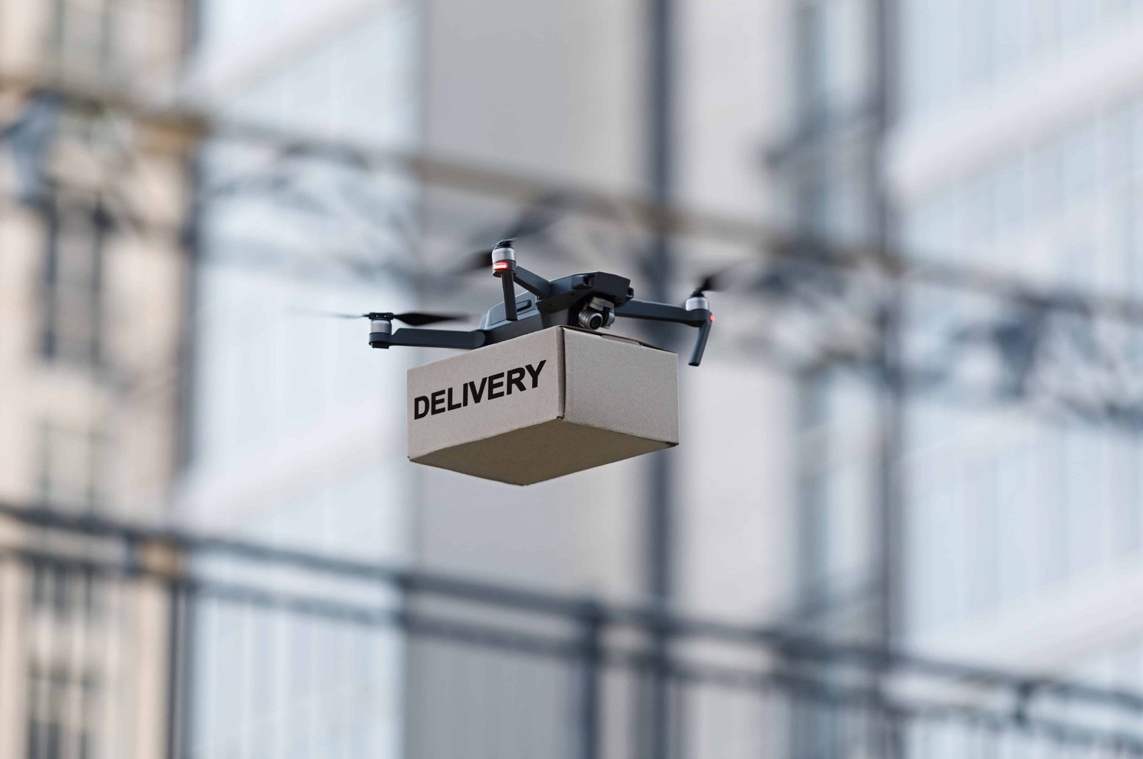 drone-with-cardboard-parcel-and-remote-control-del-2022-12-16-07-10-17-utc (1)